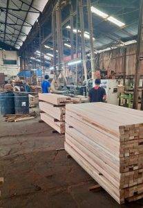 Craftsman sanding wood surface for luxury villa construction