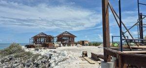Island resort villa build in progress, elevated above sand and sea breeze