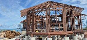 Touchwood craftsmen assembling Merbau hardwood frame for a beachfront bungalow on a tropical island